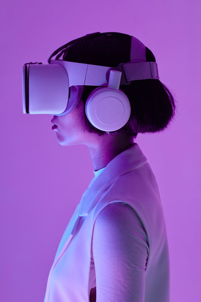 about-02 Side profile of a woman wearing VR goggles in a studio with purple lighting, embodying future tech.